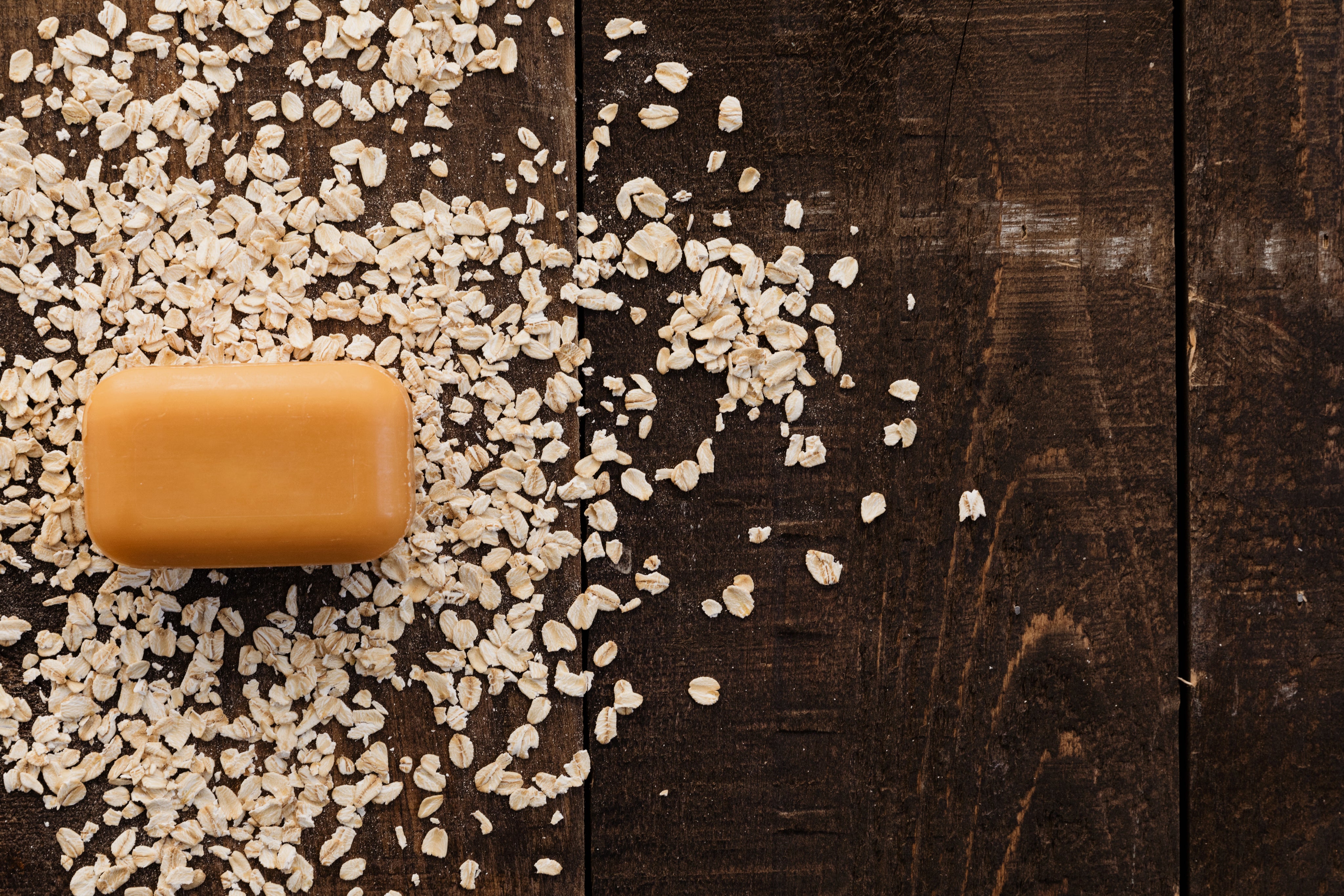 soap bar on top of oatmeal on dark table