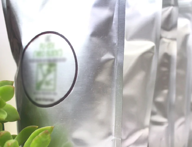Close-up of a mylar bag filled with tea, blurred background